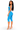 A woman modeling a bright blue ribbed two-piece set consisting of a cutout crop top and matching ribbed capri leggings, paired with clear high-heeled sandals, against a plain white background.