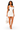 A woman modeling a white halter-neck mini dress with a side cutout, holding a white quilted handbag against a plain white background.