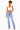 A woman modeling a pair of light-wash blue high-rise jeans with a white crop top, standing against a plain white background.