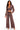 A woman modeling a matching two-piece lounge set in a washed, muted mauve-brown color. The set includes a long-sleeve cropped top with a deep V-neck and wide-leg pants with a drawstring waist, photographed against a solid white background.