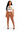 A woman modeling a white cropped graphic T-shirt tied at the waist and sheer brown mesh high-waisted leggings, paired with black strappy heels, against a plain white studio background.