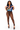 A woman modeling a sheer brown mesh bodysuit with a matching blue graphic crop top and black strappy heels, posed against a solid white background.