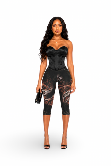 Straight Front View
Alt Text: Front view of Honor modeling Deadly Snake Print Detail Mesh Stretch Capri Leggings paired with a black satin corset top and black heels.