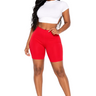 Woman wearing a white crop top and red shorts on a white background