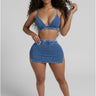 Woman wearing a blue denim outfit on a plain background